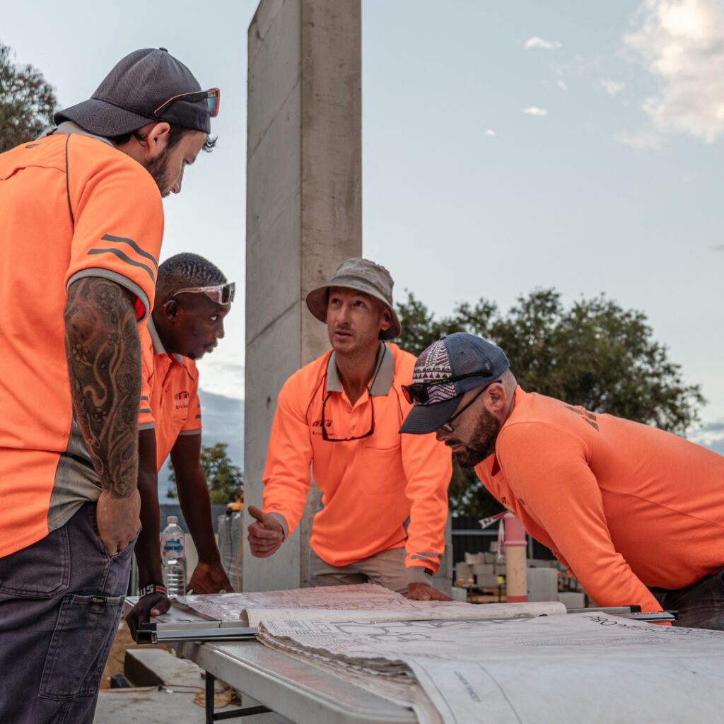 Red Rock Brickworks team reviewing bricklaying plans on a Perth construction site